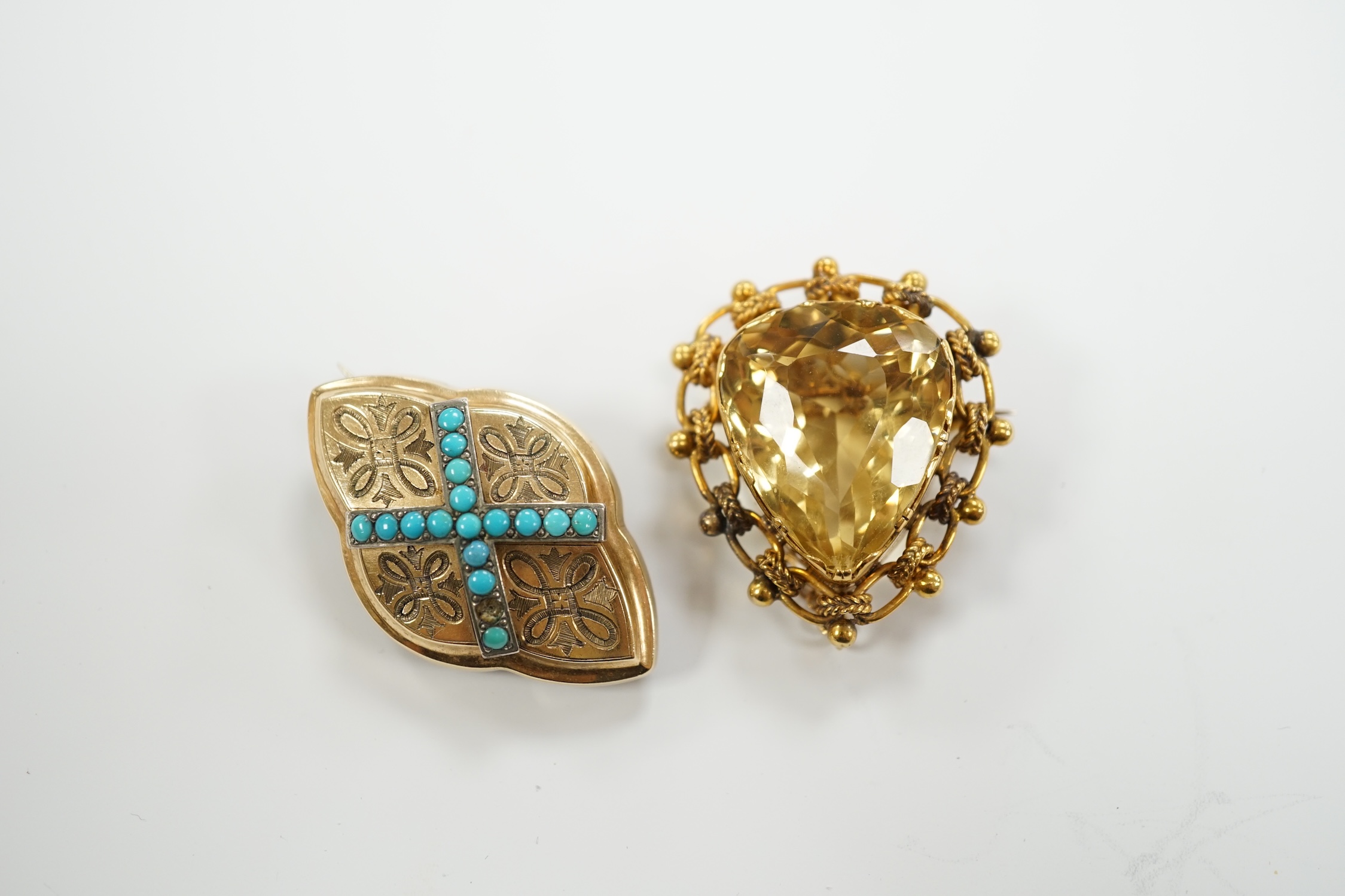 An Edwardian yellow metal mounted single stone pear cut citrine set brooch, 37mm and an earlier yellow metal and turquoise set lozenge shaped brooch, gross weight 23.9 grams.